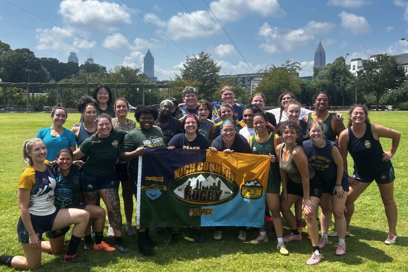 A group of players and first-timers with the High Country Rugby banner at Historic Fourth Ward Park in Atlanta